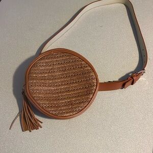 Tan circular leather bag with tassel
